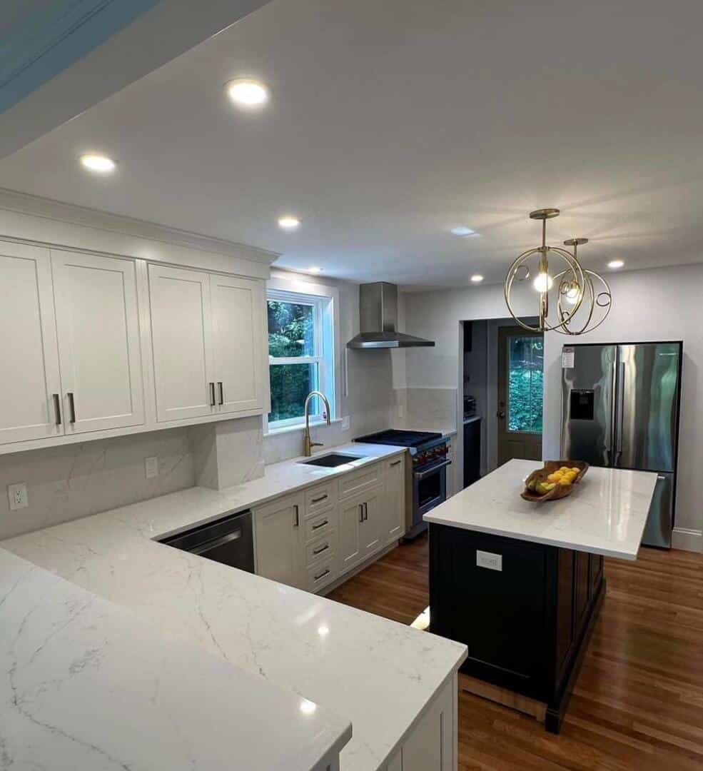Kitchen with recessed lighting and pendant fixtures by Pro Electrical